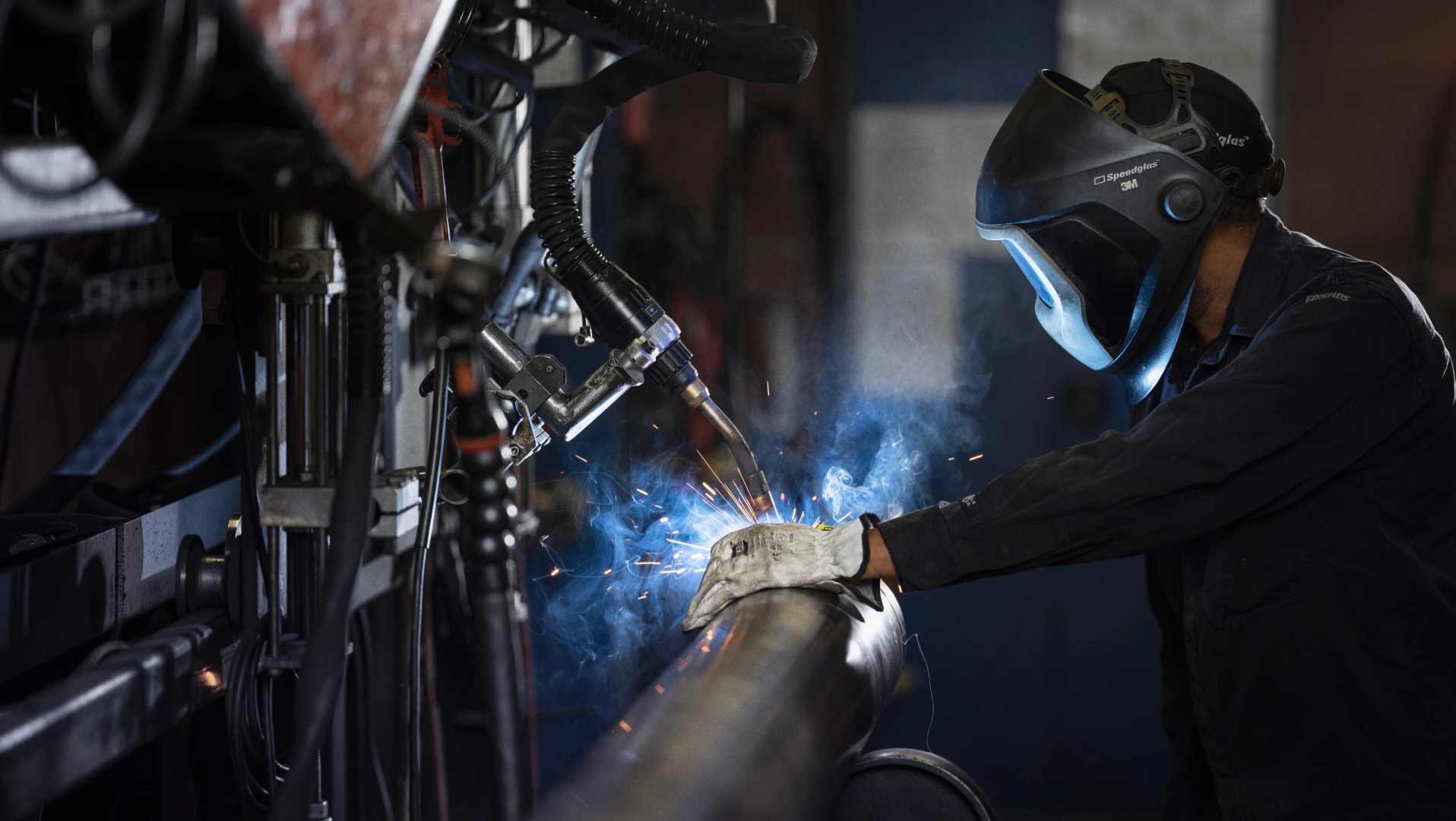 Man welding a metal tube