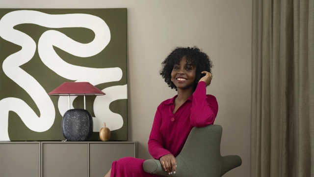 Woman sitting on a office chair smiling towards the camera
