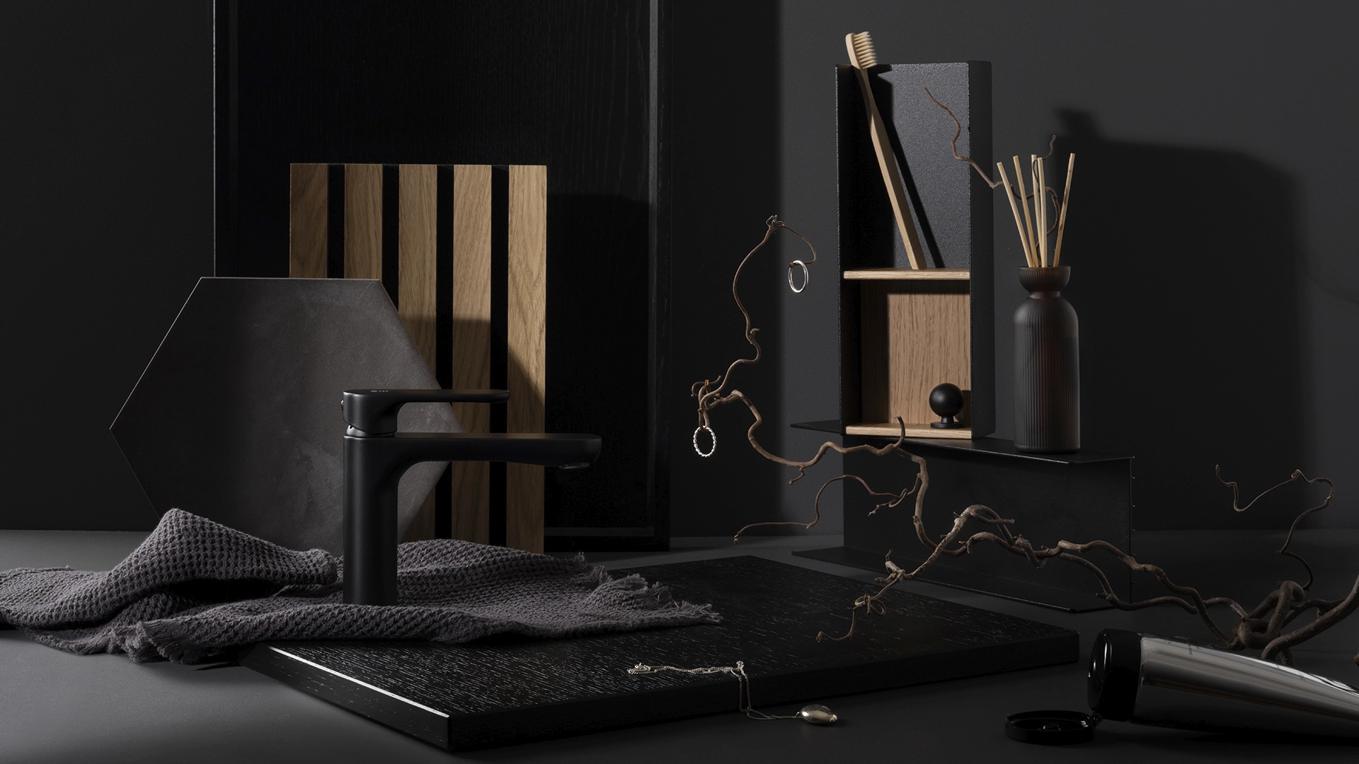  Stylish decor and decoration for a dark bathroom, scent sticks, black metal and wood wall shelf, wooden planks, a branch, black towels and a black faucet