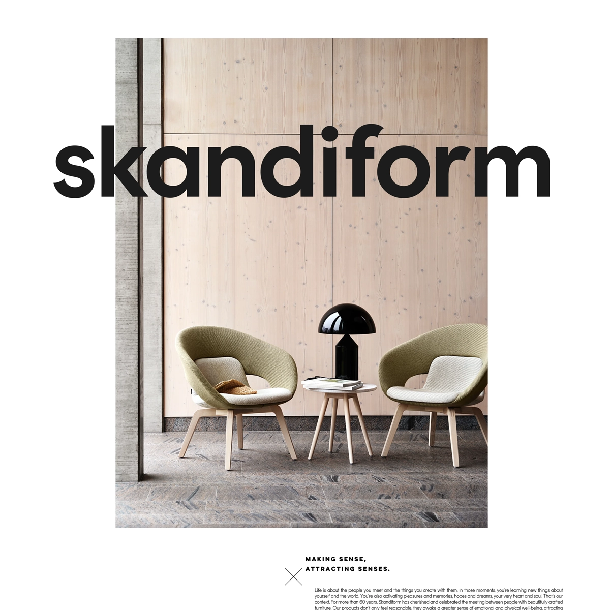 Two light green chairs in a room with a wooden wall and the skandiform logotype